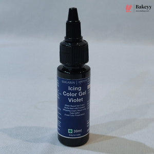 A 30ml bottle of Sugarin Baking Color Gel in the violet shade, featuring a dark blue label and a black plastic dropper cap, set against a light gray fabric background.