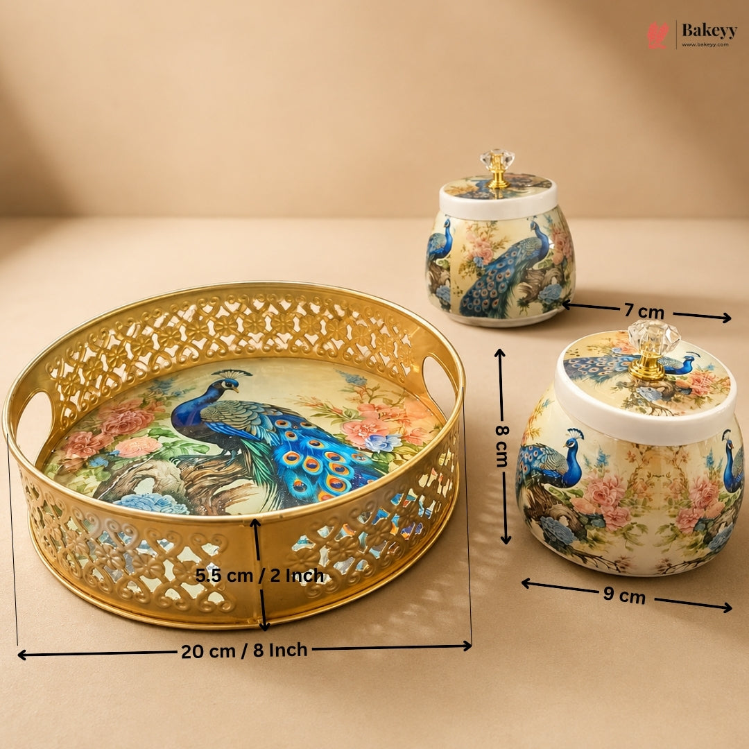 Three decorative ceramic baking containers with peacock illustrations and gold-tone cutout lids, shown with dimension arrows and labels on a beige background. A Bakeeyz logo appears in the top right corner.