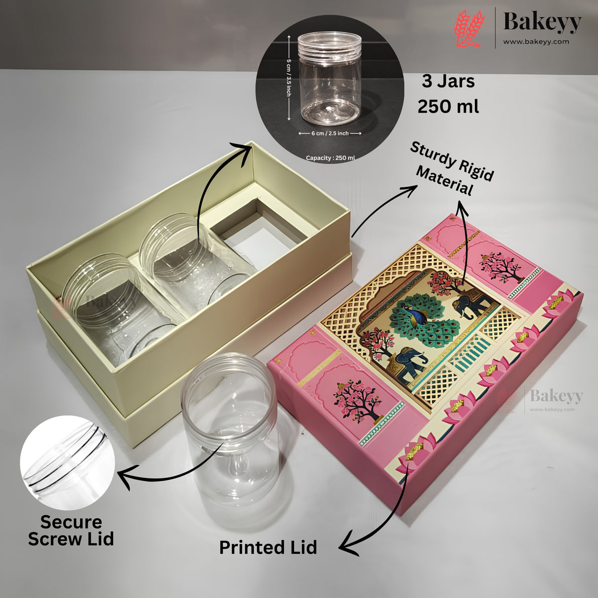 A set of three 250 ml clear plastic jars with printed lids, shown in their packaging. The set includes a cream-colored inner box with two jars, a pink decorative outer box with one jar, and a loose clear jar in the foreground.