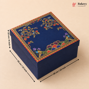 A square navy blue decorative gift box with intricate multicolor floral and peacock embroidery on the lid, shown with dimension arrows and labels indicating 28 cm by 28 cm by 10 cm.