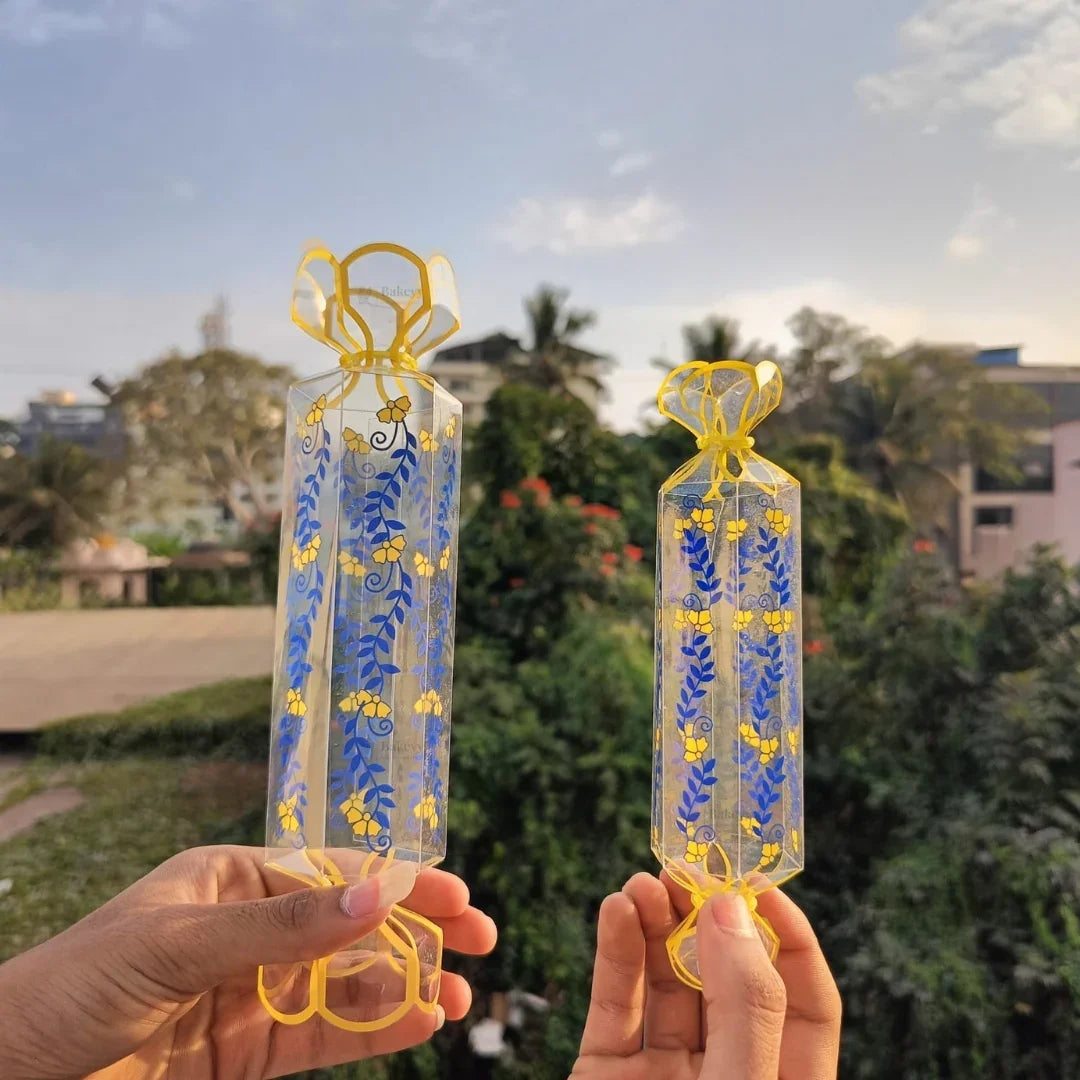 Clear transparent box with decorative floral print
Candy-style shape with twisted ends for a gift-ready look
Ideal for chocolates, candies, toffees, small treats, and favors
Great for birthdays, weddings, baby showers, festive gifting, and hampers
Lightweight, neat presentation, easy to display