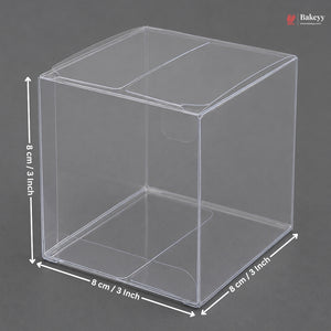 Clear plastic cube with dimensions labeled on a gray background
