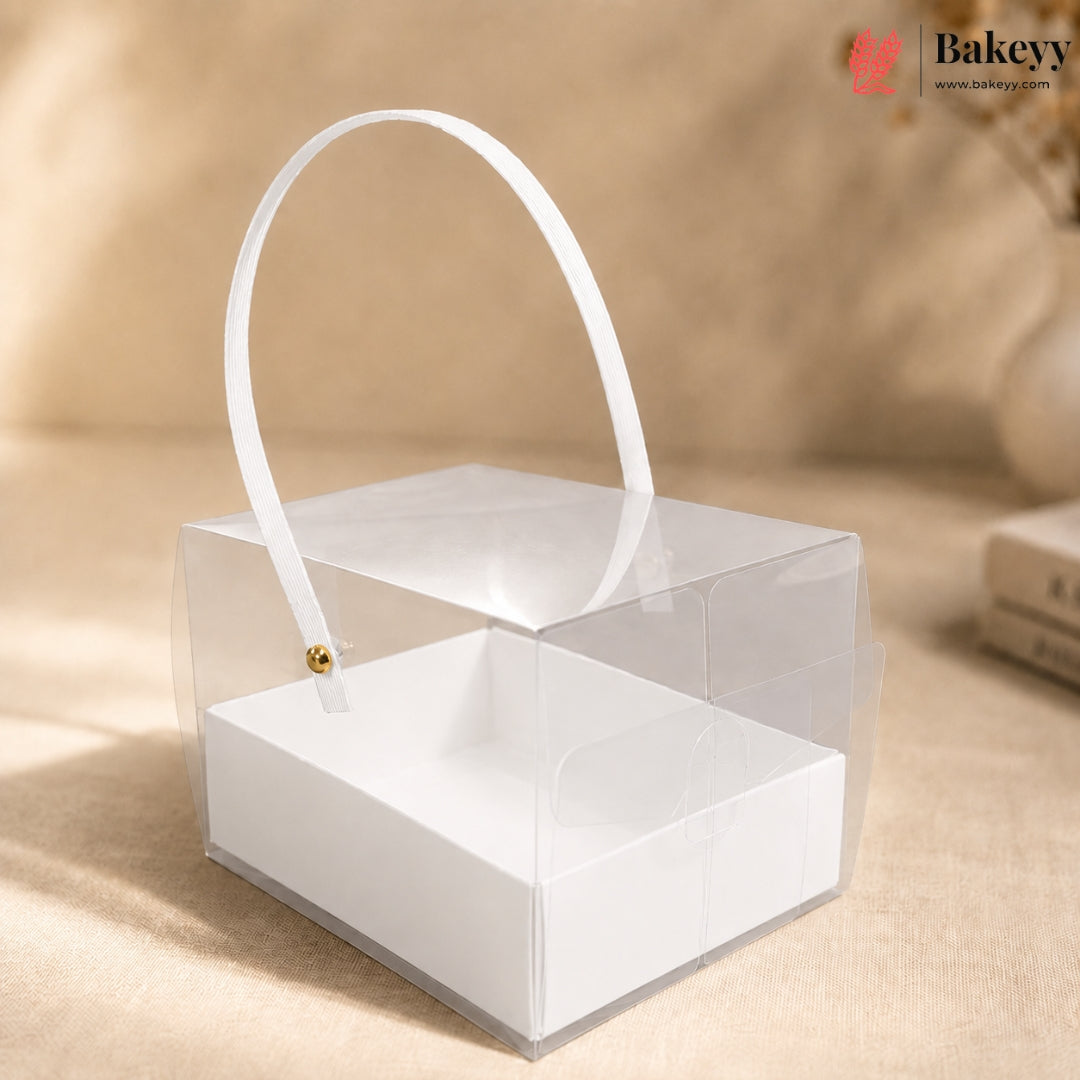 Clear acrylic box with white handle on a beige background, featuring the Bakey brand.