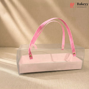 Clear box with pink velvet handle on a beige background, featuring the Bakeyy brand.