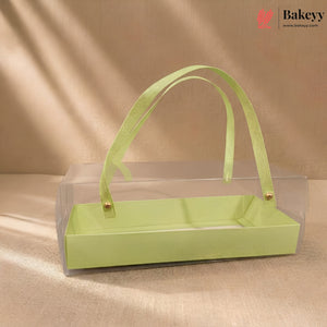 Green rectangular box with a ribbon handle on a beige background, featuring the Bakeyy brand.