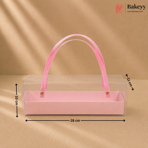 Pink rectangular box with a handle on a beige background, featuring dimensions.
