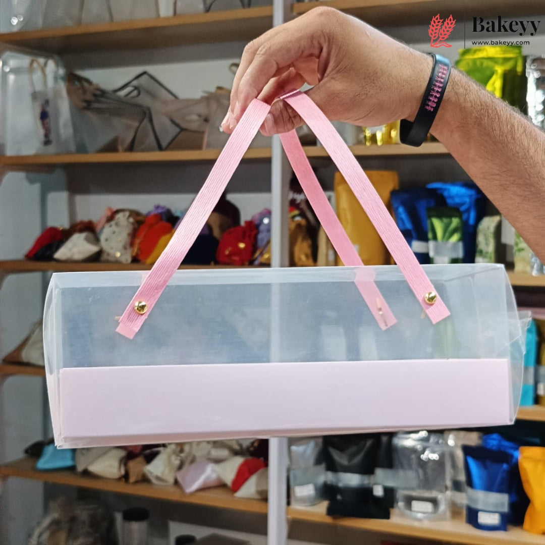Clear plastic bag with pink handles held by a hand in a store setting
