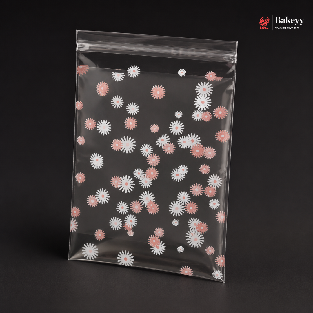 Clear plastic bag with pink and white floral pattern on a black background, featuring the brand 'Bakeyy'.