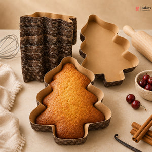 Tree-shaped cake in a mold with baking tools and ingredients on a table