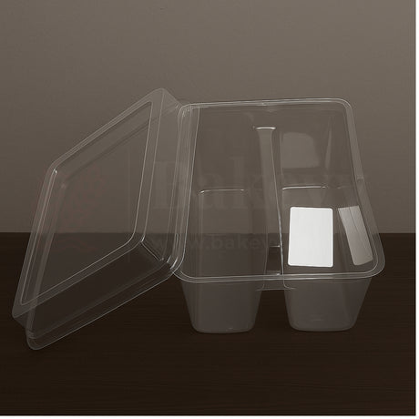 Clear plastic container with compartments on a dark surface