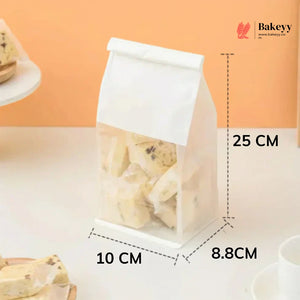 Clear plastic bag with cookies, labeled dimensions, and Bakeyy branding.