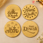 Four round gold-colored Diwali-themed engraved coasters or placemats arranged in a 2x2 grid on a beige surface. The designs include a diya, stars, fireworks, and the words 'Happy Diwali' in dark brown lettering.