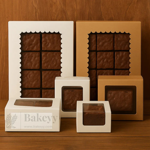 Assorted brown bakery boxes with clear windows displaying brownies, from Bakeyy.com wholesale baking supplies.