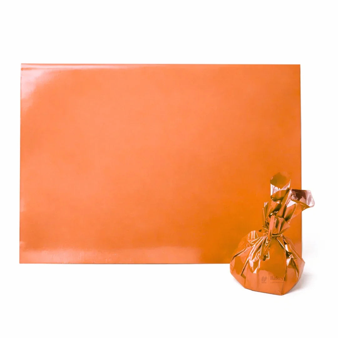 Glossy orange wrapping sheet and gift bag for bakery hamper packaging from Bakeyy.com