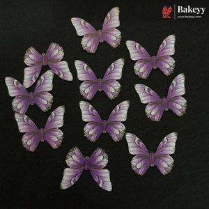 Ten purple and white butterfly-shaped decorative pieces arranged on a dark textured background, with the Bakeyy logo in the top right corner.