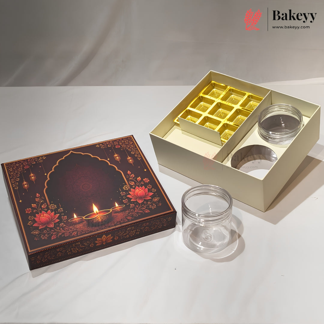 A gift box set for sweets or chocolates, featuring a dark brown decorative lid with floral and diya (oil lamp) illustrations, an open cream-colored box with a gold tray and two clear plastic jars, and two empty clear plastic jars on a white draped fabric background.