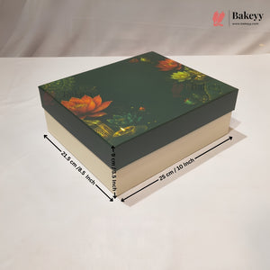 A rectangular bakery gift box with a dark green lid featuring a lotus flower and gold foil pattern, shown with dimension arrows and text indicating 23.5 cm by 25 cm by 6 cm (8.