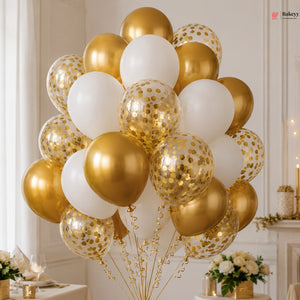 Decorative arrangement of gold, white, and clear balloons with confetti in a formal setting.