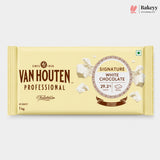 A 1 kg bar of Van Houten Professional Signature White Chocolate in a pale cream-colored wrapper, shown against a light gray background with a Bakeyy logo in the top right corner.