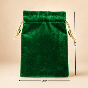 Green velvet drawstring pouch with measurements on a beige background