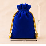 Blue velvet drawstring bag with gold accents and measurements on a beige background