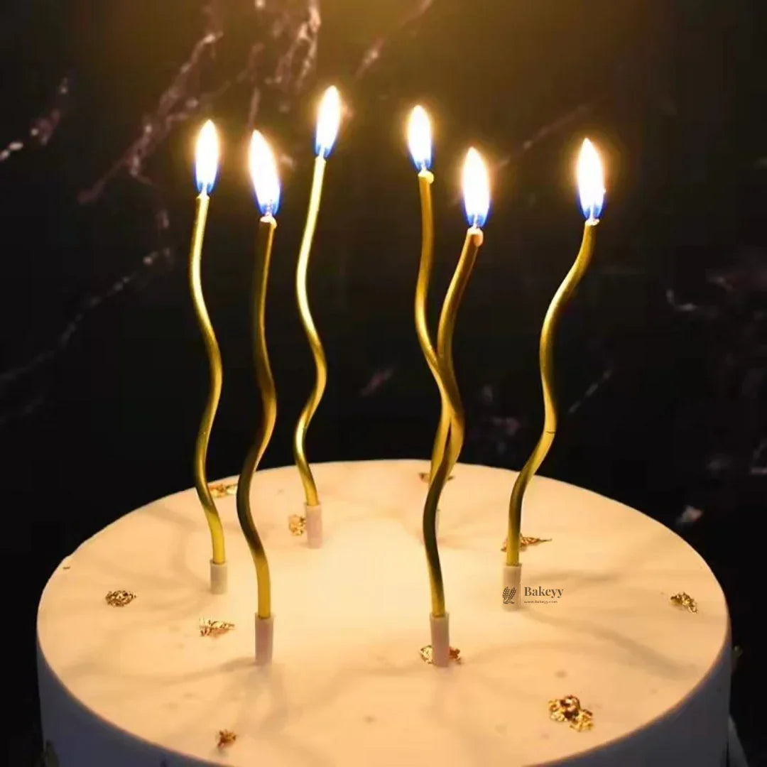 Gold wavy spiral birthday candles with holders on a white cake, Bakeyy baking supplies