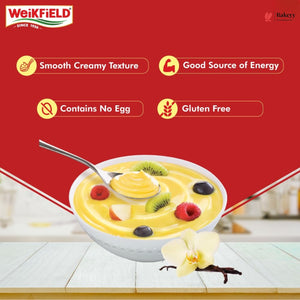 Fruit bowl with vanilla pudding on a white surface, featuring Weikfield logo and product features.