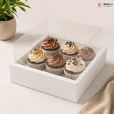 Clear box with cupcakes on a light surface, featuring the Bakeyy brand.