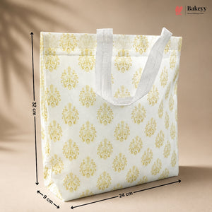 White tote bag with gold floral patterns and measurements on a beige background