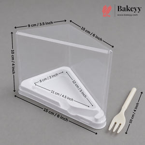 Clear plastic bakery display box with a white triangular base, shown with dimension arrows and labels on a gray background, plus a cream-colored serving fork and a Bakeyy logo in the top right.