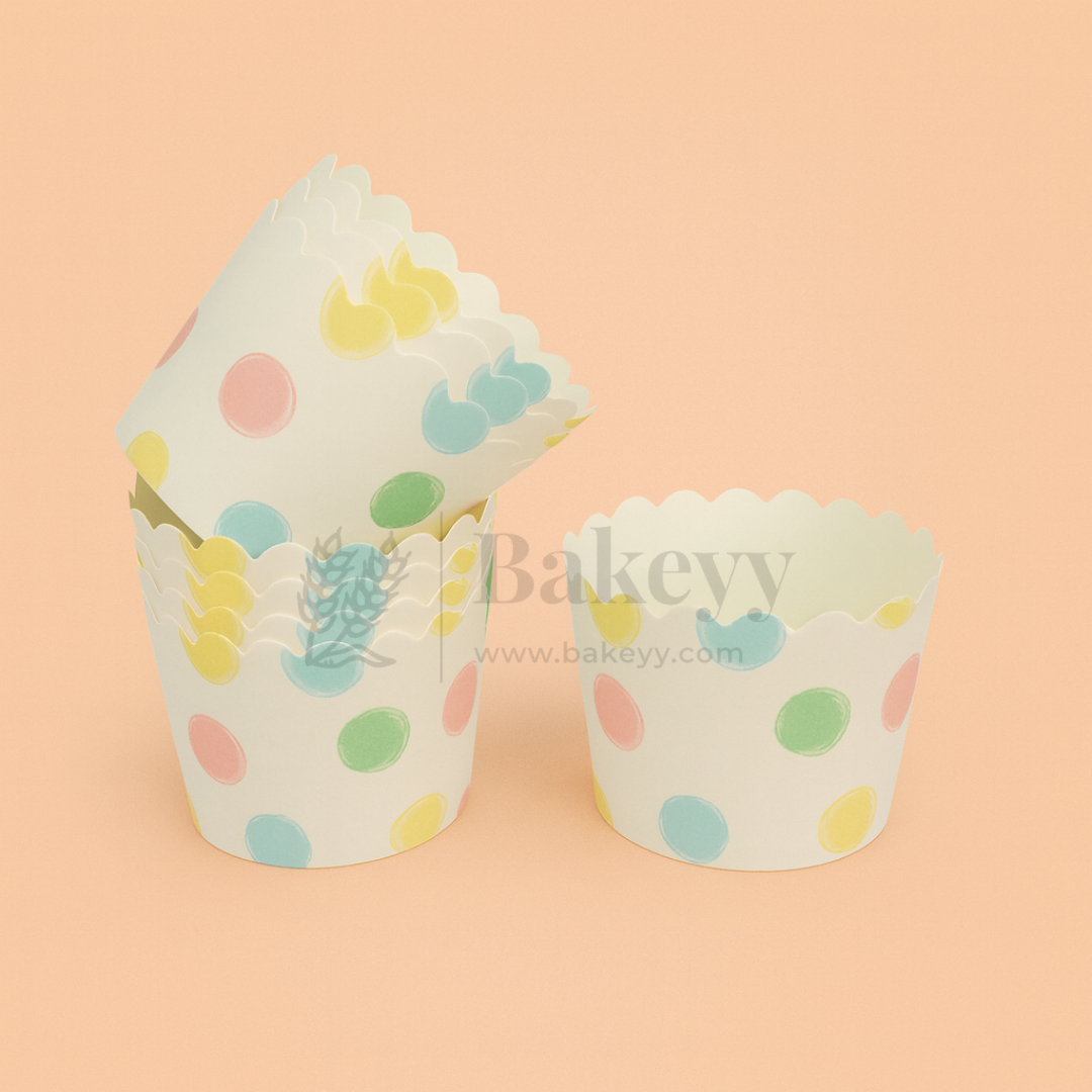 Two cupcake liners with polka dot and plant design on a peach background, branded 'Bakevv'.
