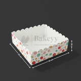 Polka dot cake box with dimensions on a black background, featuring the brand 'Bakeyy'.