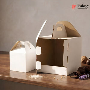 Two cardboard boxes with handles on a wooden surface, featuring the Bakeyy brand.