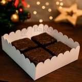 Box of brownies with a festive background featuring lights and a star.
