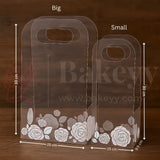 Clear packaging boxes with floral design and measurements on a wooden background, featuring the brand 'Bakeyy'.