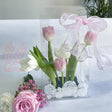 Clear packaging with pink and white tulips and roses on a light background