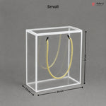 Small clear cube with yellow rope inside, dimensions labeled, on a gray background