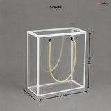 Small clear cube with yellow rope inside, dimensions labeled, on a gray background