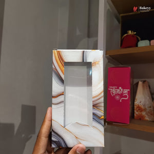 Marble-patterned box held by a hand with a blurred background