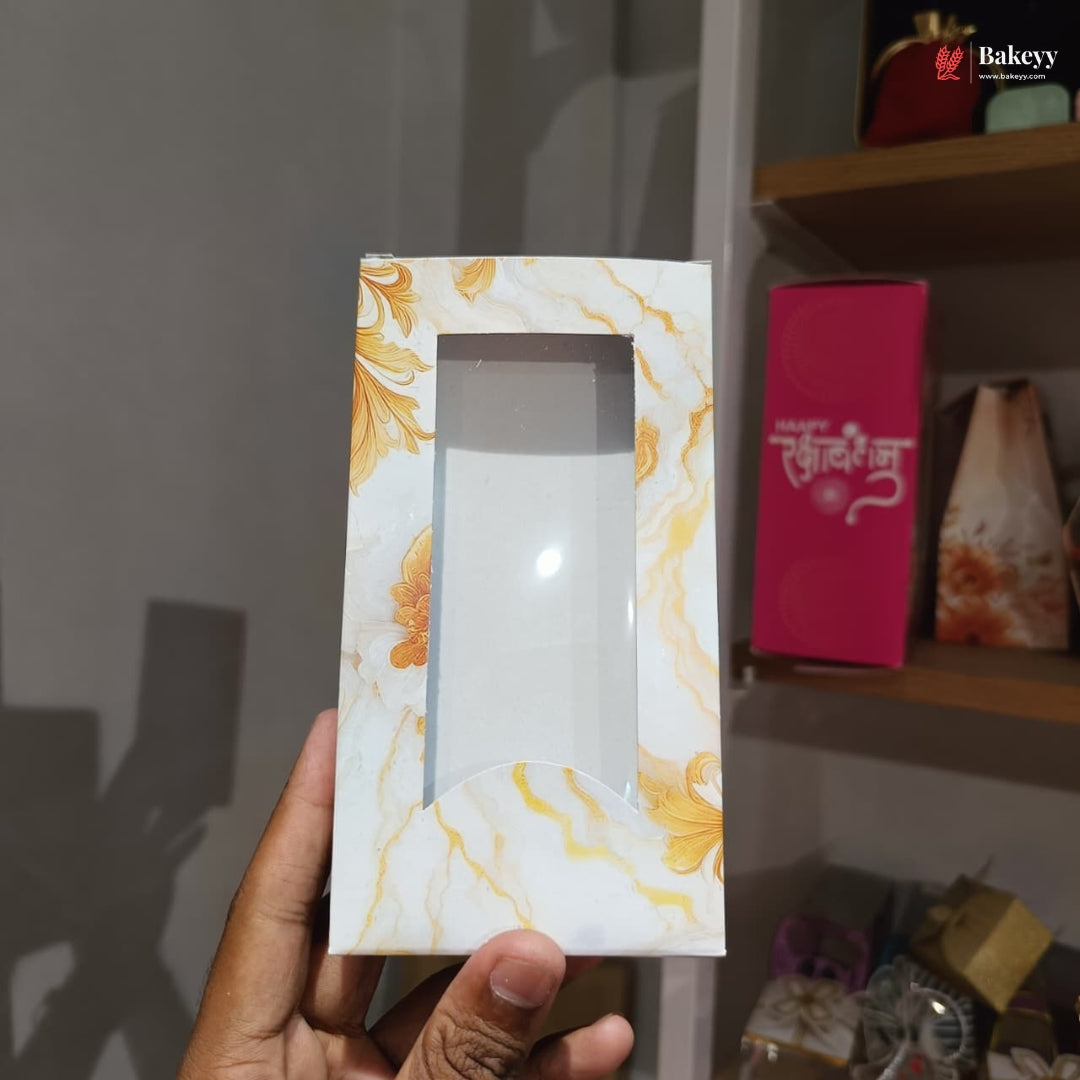 Marble-patterned box held by a hand with a blurred background