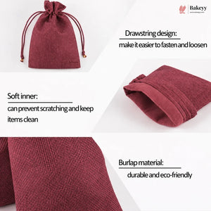 A dark red/burgundy burlap drawstring pouch shown in a four-panel infographic with text highlighting its features: drawstring design, soft inner lining, burlap material, and eco-friendly appeal. The Bakeey brand logo is visible in the top right corner.