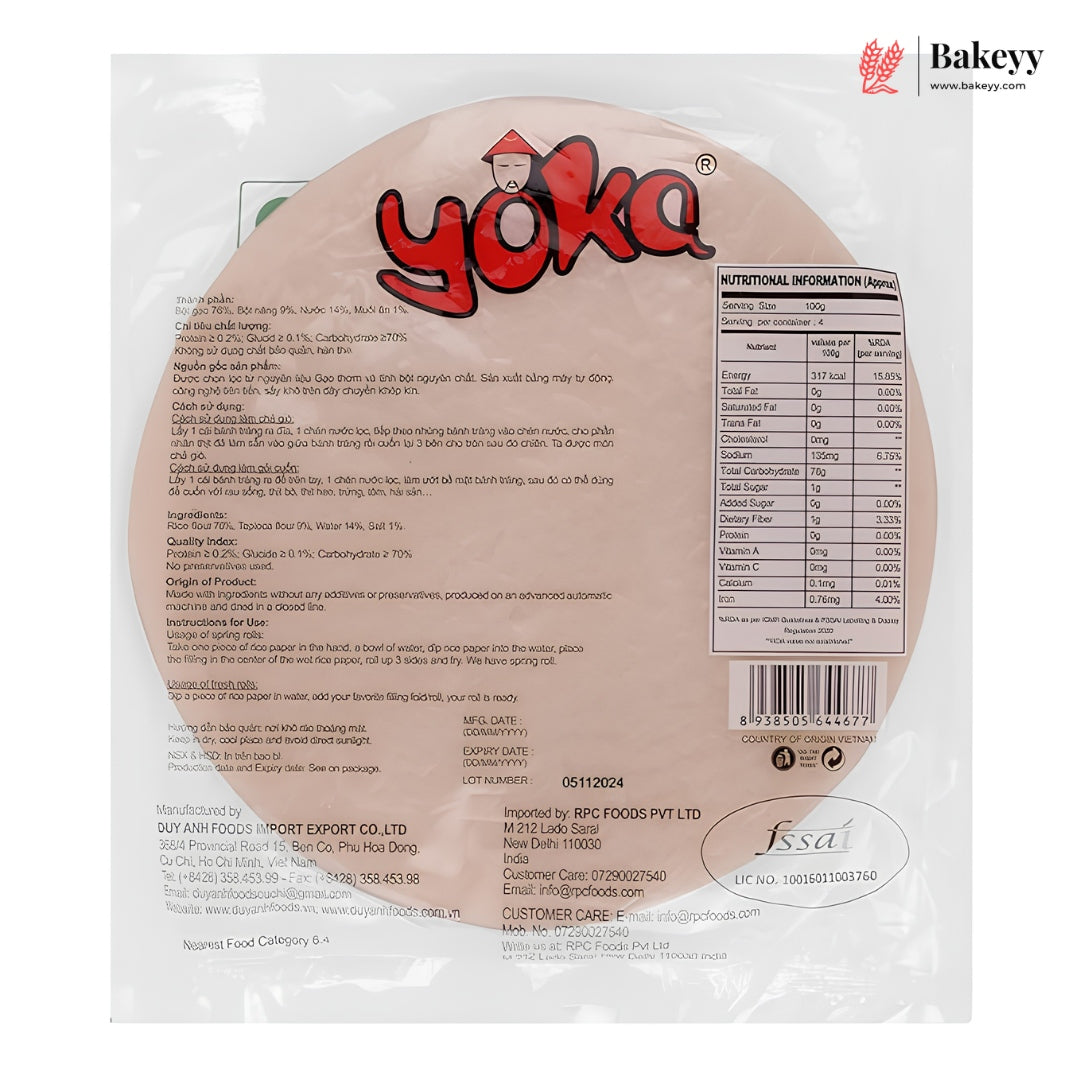Back view of a packaged round rice cake on a white background, showing the Bakeyy logo, product details, nutrition facts, and a barcode. The package is clear plastic with printed text and branding.