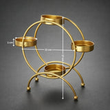 Gold metal diya stand with four holders, dimension labels, on a dark background