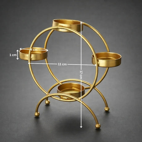 Gold metal diya stand with four holders, dimension labels, on a dark background