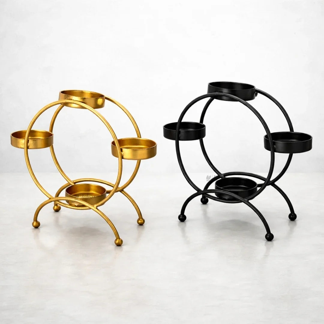 Gold and black metal diya stands with four holders for festive decor, Bakeyy.com product image
