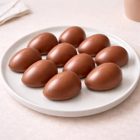 Smooth chocolate eggs on a white plate, Bakeyy baking supplies photo