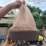 Small velvet gift hamper basket with net cover, held outdoors, Bakeyy hamper packaging.