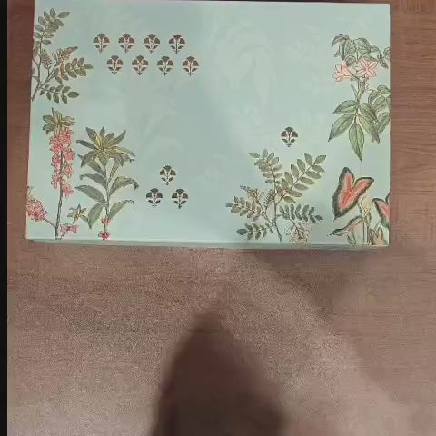 Luxury rigid gift box with botanical floral print
2 printed jars with premium gold lids
9-cavity tray ideal for sweets/chocolates
Ideal for dry fruits, chocolates, mithai, cookies and more
Strong build and premium look for festive gifting