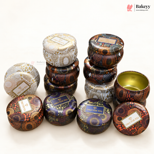 A group of round metal tin containers with decorative patterns, shown on a clean white background. Some tins are stacked, and one open tin is displayed to show the gold interior.