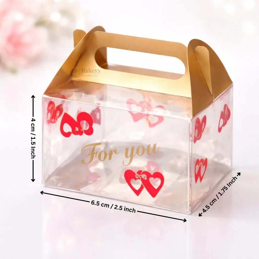 Clear plastic gift box with gold handle, red heart design, and 'For you' text, Bakeyy packaging